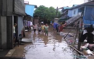 Community members walked through flooding in the community during rainy season