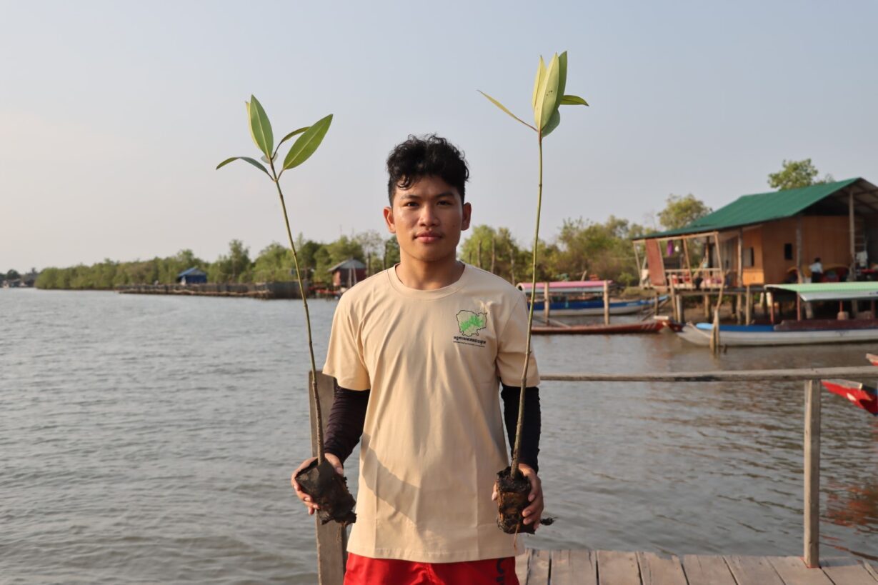 Young community members participate in promoting mangrove planting.